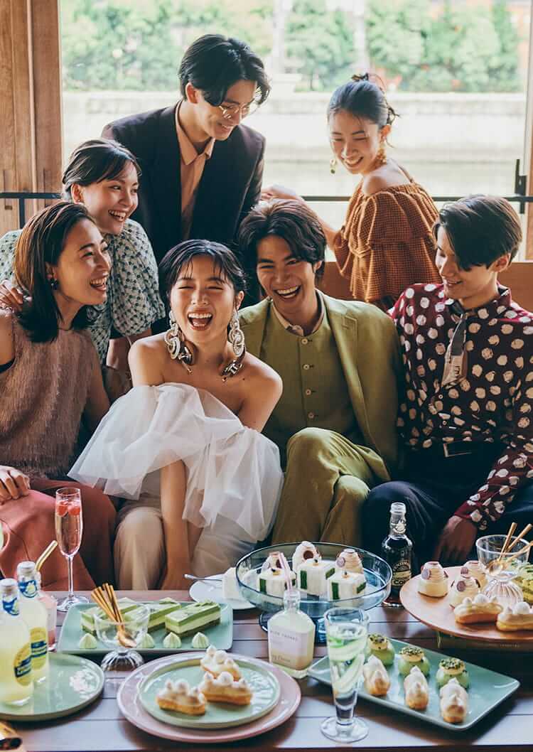 新郎新婦を友人たちが囲んで、笑い合うメインビジュアル
